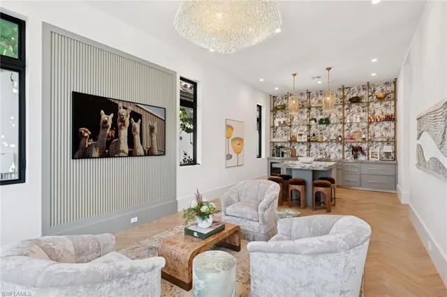 a living room with furniture and kitchen view