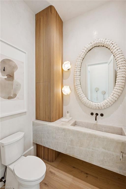 1990 7th Street South Naples, FL 34102 - Photo 17 of 49 a bathroom with a toilet a sink and mirror