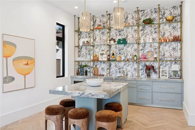 a kitchen with granite countertop a table and chairs