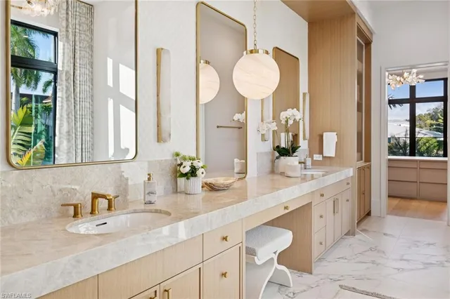a bathroom with a granite countertop sink and a large mirror