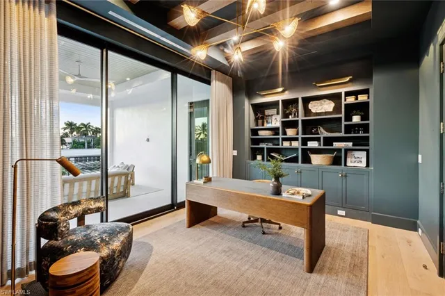 a living room with furniture a rug and a large window