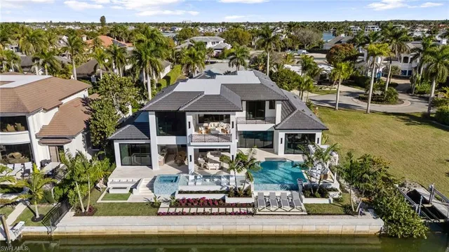 a aerial view of a house with a yard swimming pool and outdoor seating