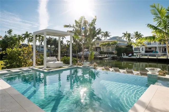 a view of a lake with a patio and a garden
