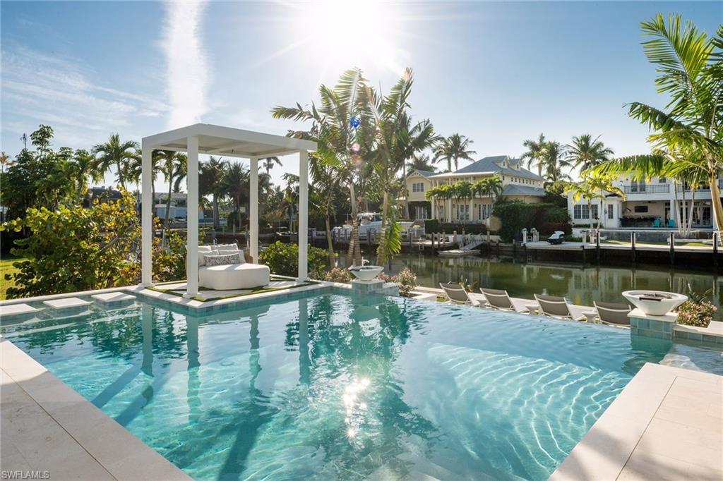 1990 7th Street South Naples, FL 34102 - Photo 3 of 49 a view of a lake with a patio and a garden