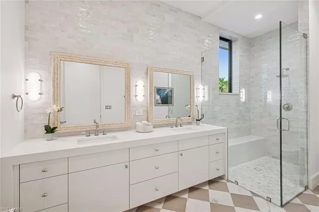 a bathroom with a double vanity sink and mirror
