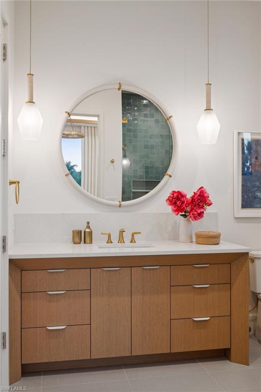 1990 7th Street South Naples, FL 34102 - Photo 33 of 49 a bathroom with a sink and a mirror
