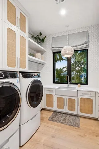 a view of a kitchen with a washer and dryer
