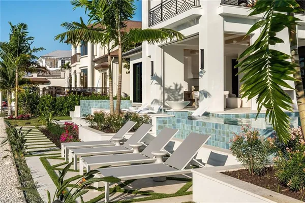 a living room with patio furniture and a large window