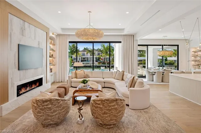 a large kitchen with granite countertop a large island in the center and stainless steel appliances