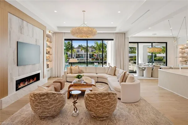 a large kitchen with granite countertop a large island in the center and stainless steel appliances