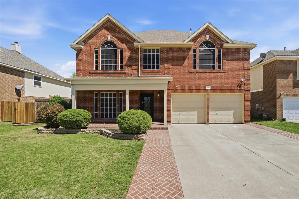 2133 Rustic Ridge Drive Keller, TX 76248 - Photo 2 of 40 Traditional-style home with brick siding, an attached garage, driveway, covered porch, and roof with shingles
