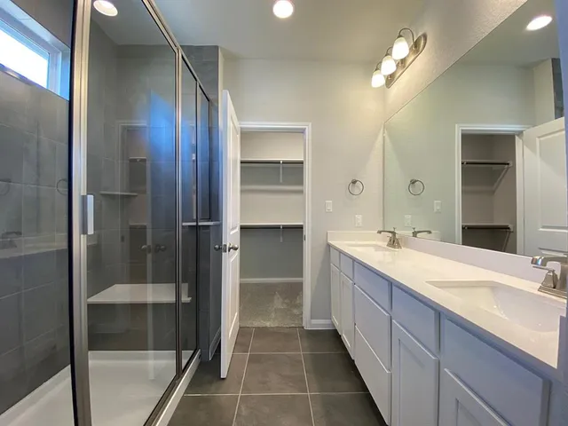 a bathroom with a double vanity sink and a mirror