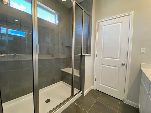a bathroom with a glass shower door