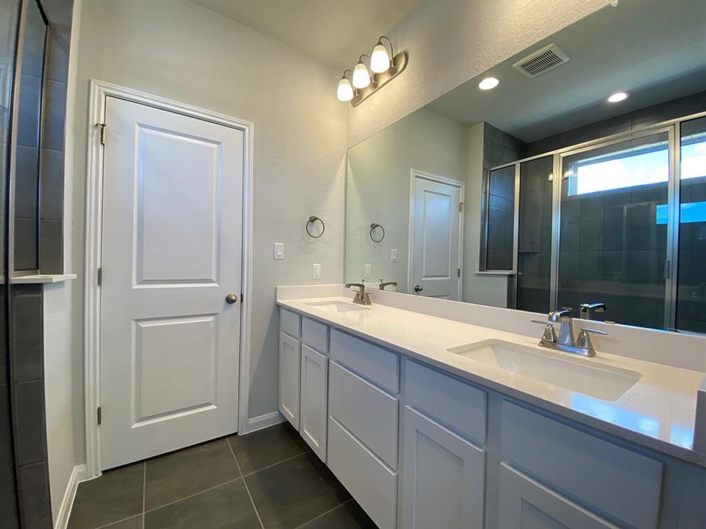 320 Creek Road, Unit 303 Dripping Springs, TX 78620 - Photo 18 of 28 a bathroom with a double vanity sink and a mirror
