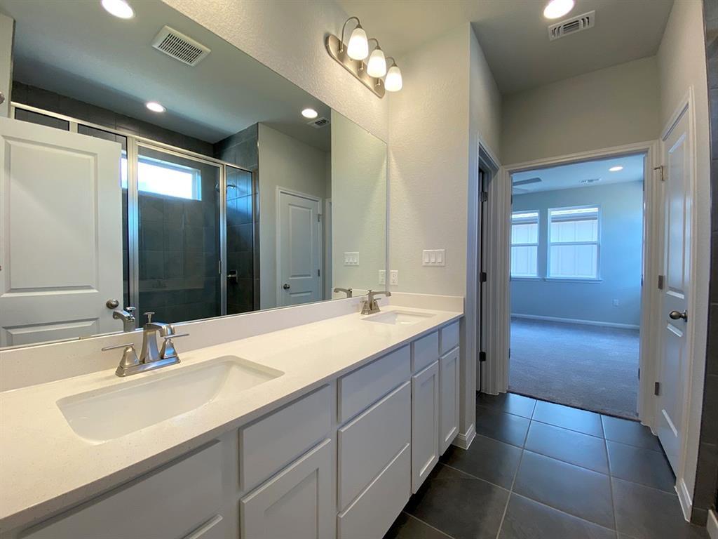 320 Creek Road, Unit 303 Dripping Springs, TX 78620 - Photo 19 of 28 a bathroom with double vanity sinks and a mirror
