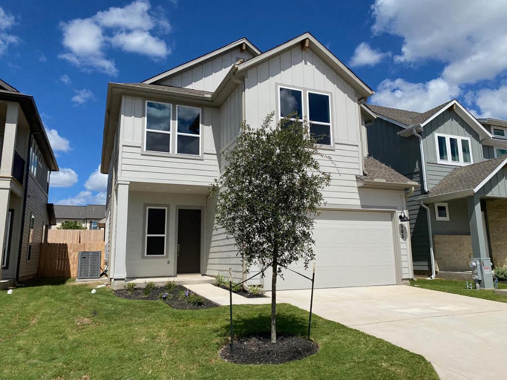 320 Creek Road, Unit 303 Dripping Springs, TX 78620 - Photo 2 of 28 a front view of a house with a yard