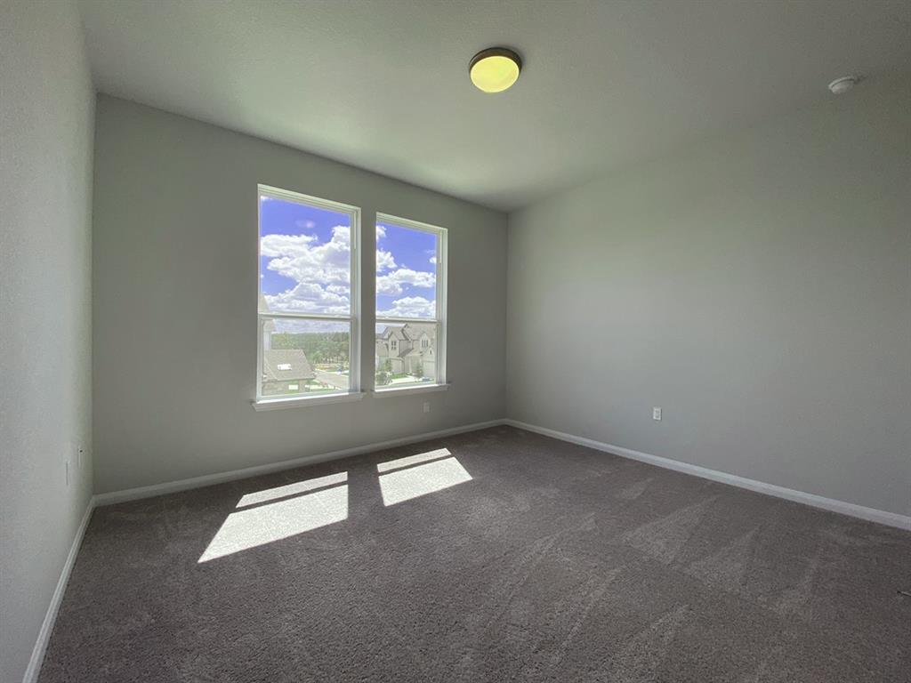 320 Creek Road, Unit 303 Dripping Springs, TX 78620 - Photo 23 of 28 an empty room with windows