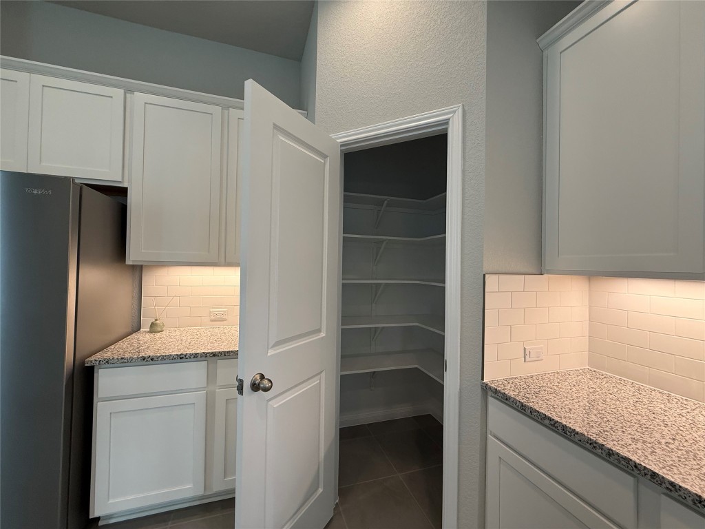 320 Creek Road, Unit 303 Dripping Springs, TX 78620 - Photo 8 of 28 a bathroom with a granite countertop sink and a mirror
