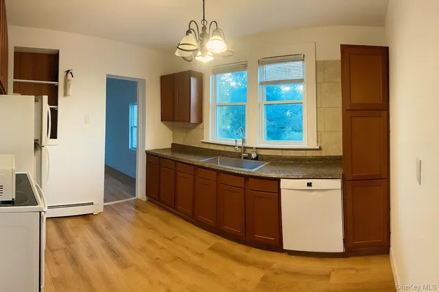 a kitchen with stainless steel appliances granite countertop a sink and a refrigerator