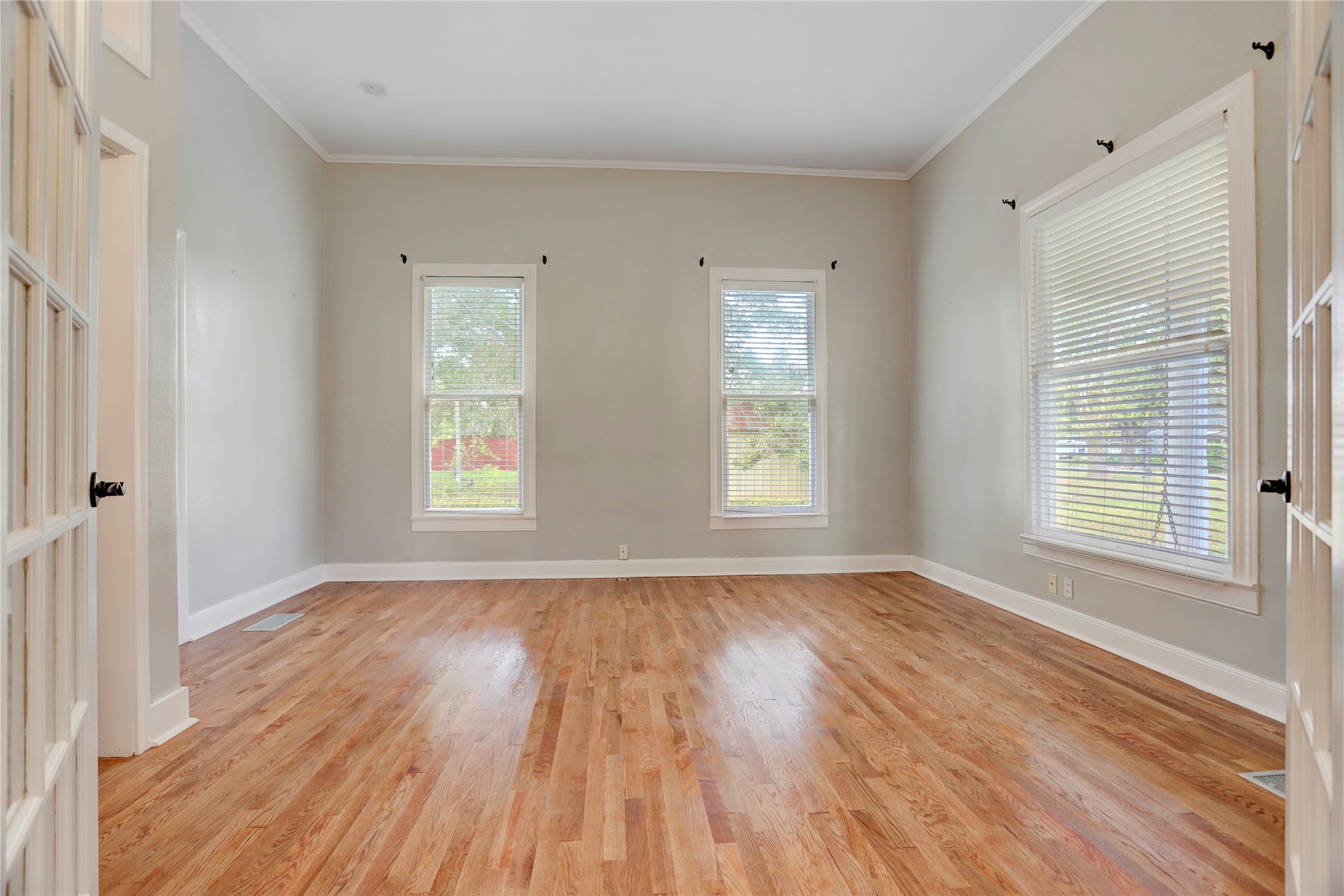 238 Bridge Street Glen Flora, TX 77443 - Photo 12 of 34 an empty room with wooden floor and windows