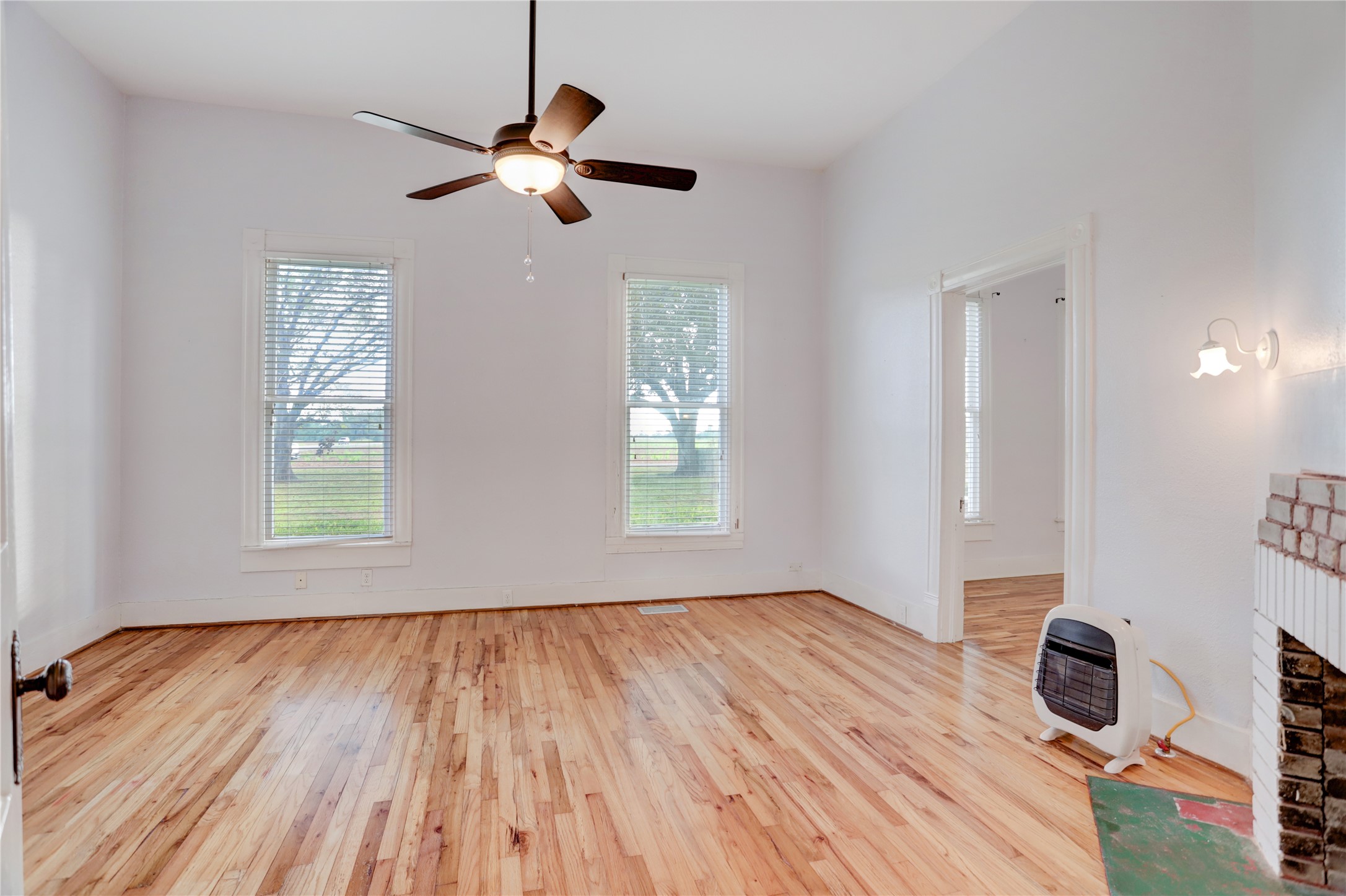 238 Bridge Street Glen Flora, TX 77443 - Photo 13 of 34 a view of an empty room with wooden floor and a window
