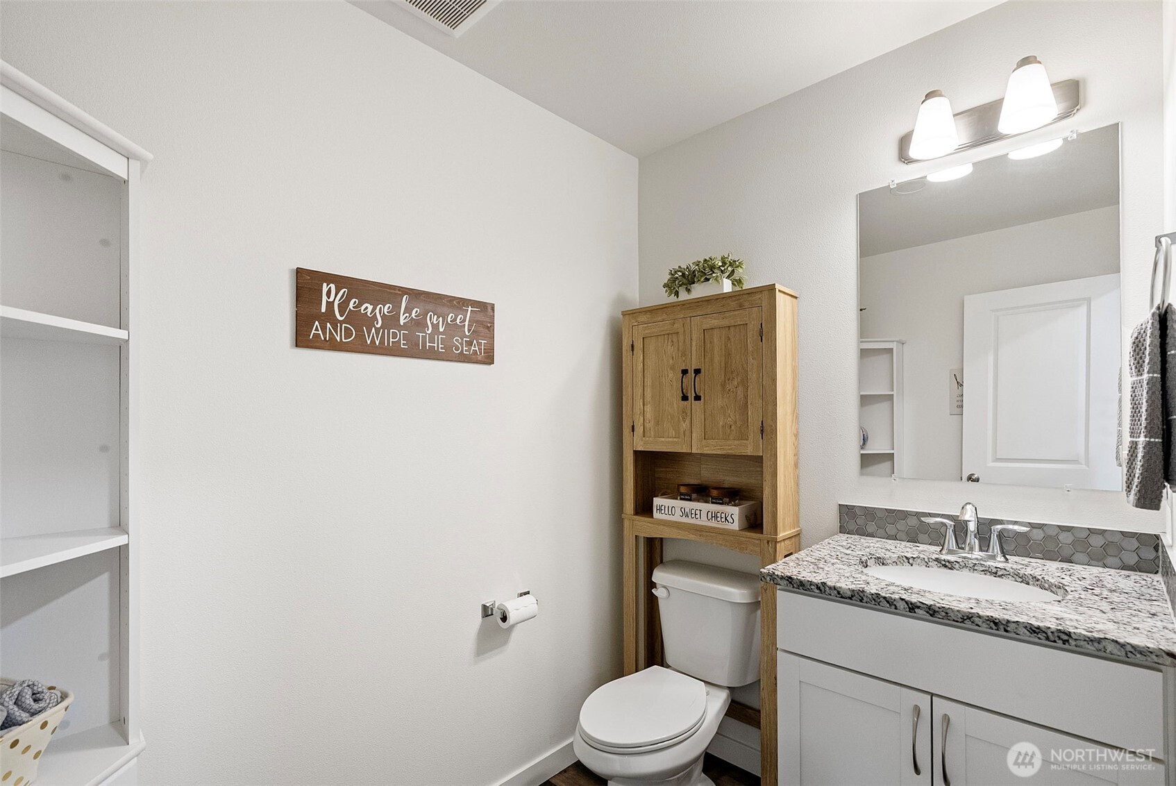 9611 West Belfair Valley Road Bremerton, WA 98312 - Photo 21 of 40 a bathroom with a granite countertop toilet sink and mirror