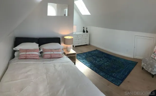 a bedroom with bed and window