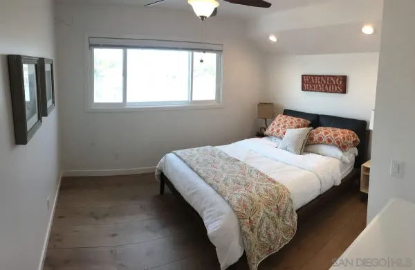 a bedroom with a bed and window