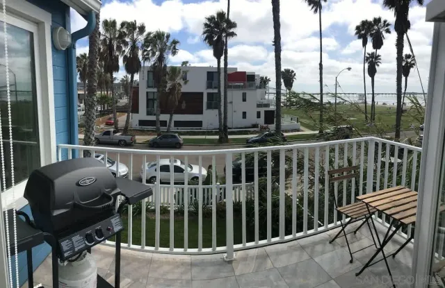 a view of a chair and tables in the balcony