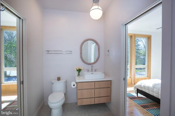 a bathroom with a toilet sink and mirror