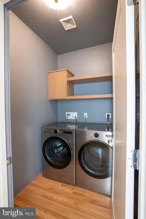 a utility room with sink dryer and washer