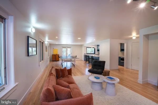 a living room with furniture and wooden floor
