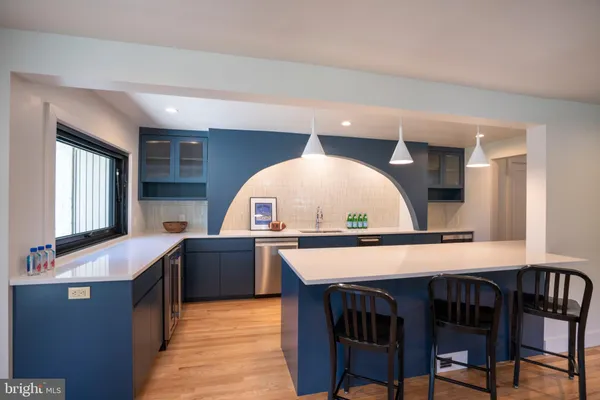 a view of kitchen island with stainless steel appliances granite countertop living room and microwave