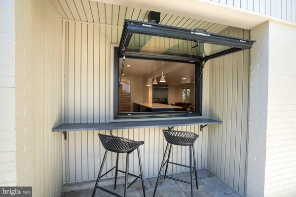 a view of a room with a table and chairs