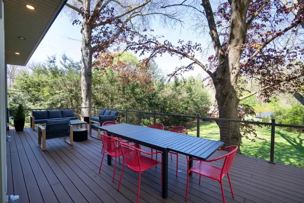 a view of a roof deck with wooden floor and fence