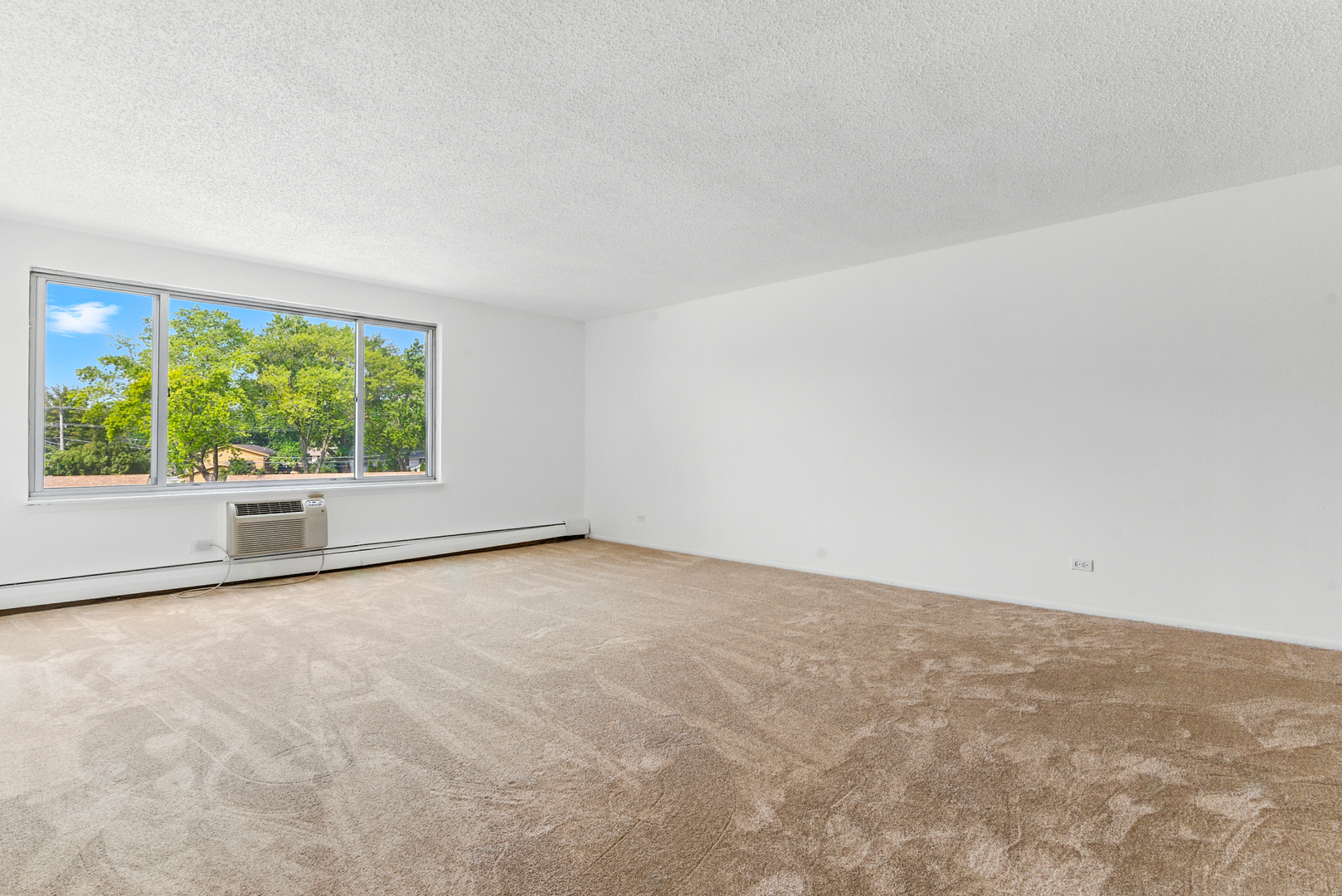 1207 South Old Wilke Road, Unit 303 Rolling Meadows, IL 60005 - Photo 5 of 34 an empty room with windows