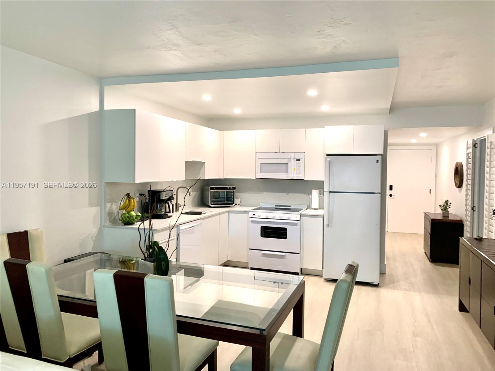 240 Galen Drive, Unit 206 Key Biscayne, FL 33149 - Photo 2 of 9 a kitchen with stainless steel appliances a refrigerator and a stove top oven