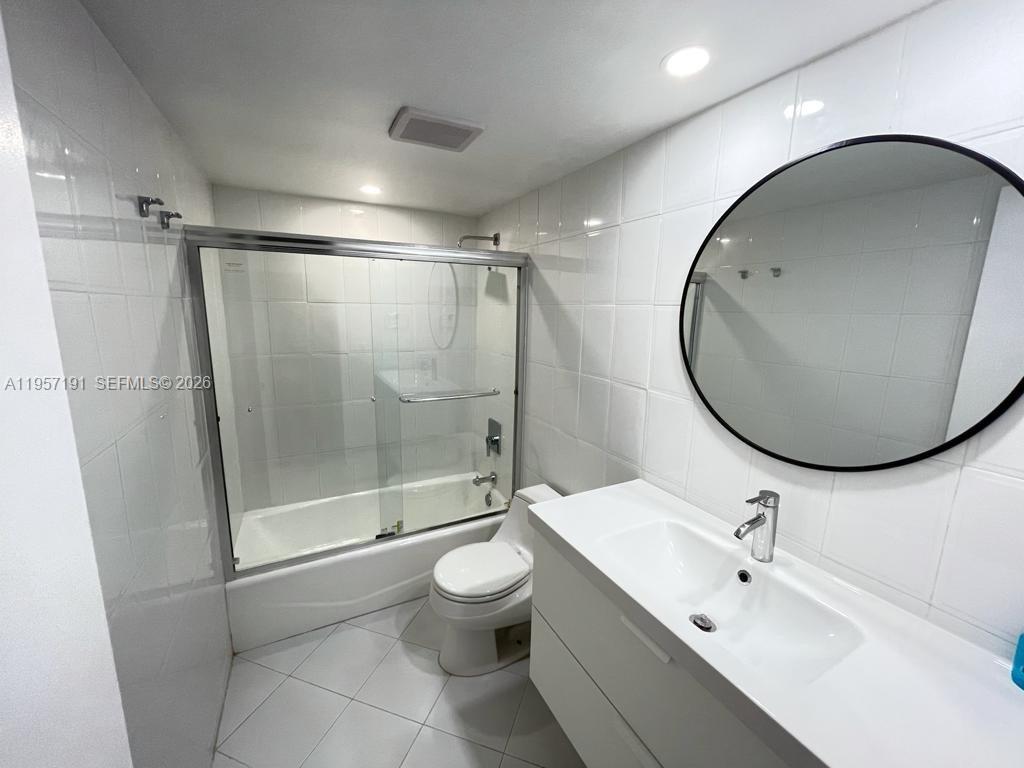 240 Galen Drive, Unit 206 Key Biscayne, FL 33149 - Photo 5 of 9 a bathroom with a sink mirror toilet and shower