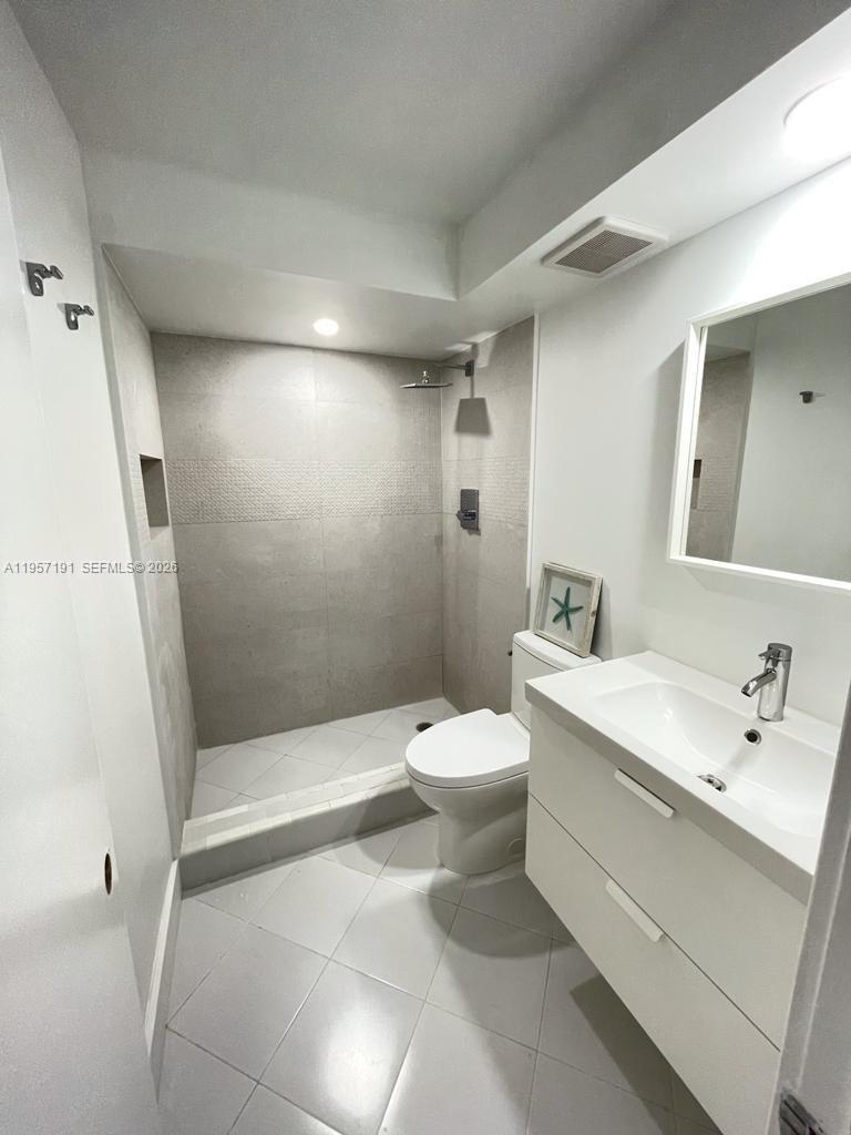 240 Galen Drive, Unit 206 Key Biscayne, FL 33149 - Photo 6 of 9 a bathroom with a toilet sink and shower