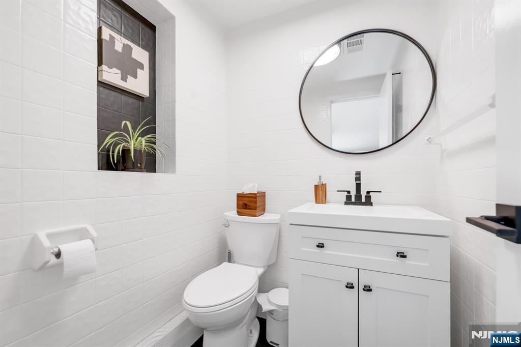 433 Piermont Road Cresskill, NJ 07626 - Photo 39 of 49 a bathroom with a sink a toilet and a mirror