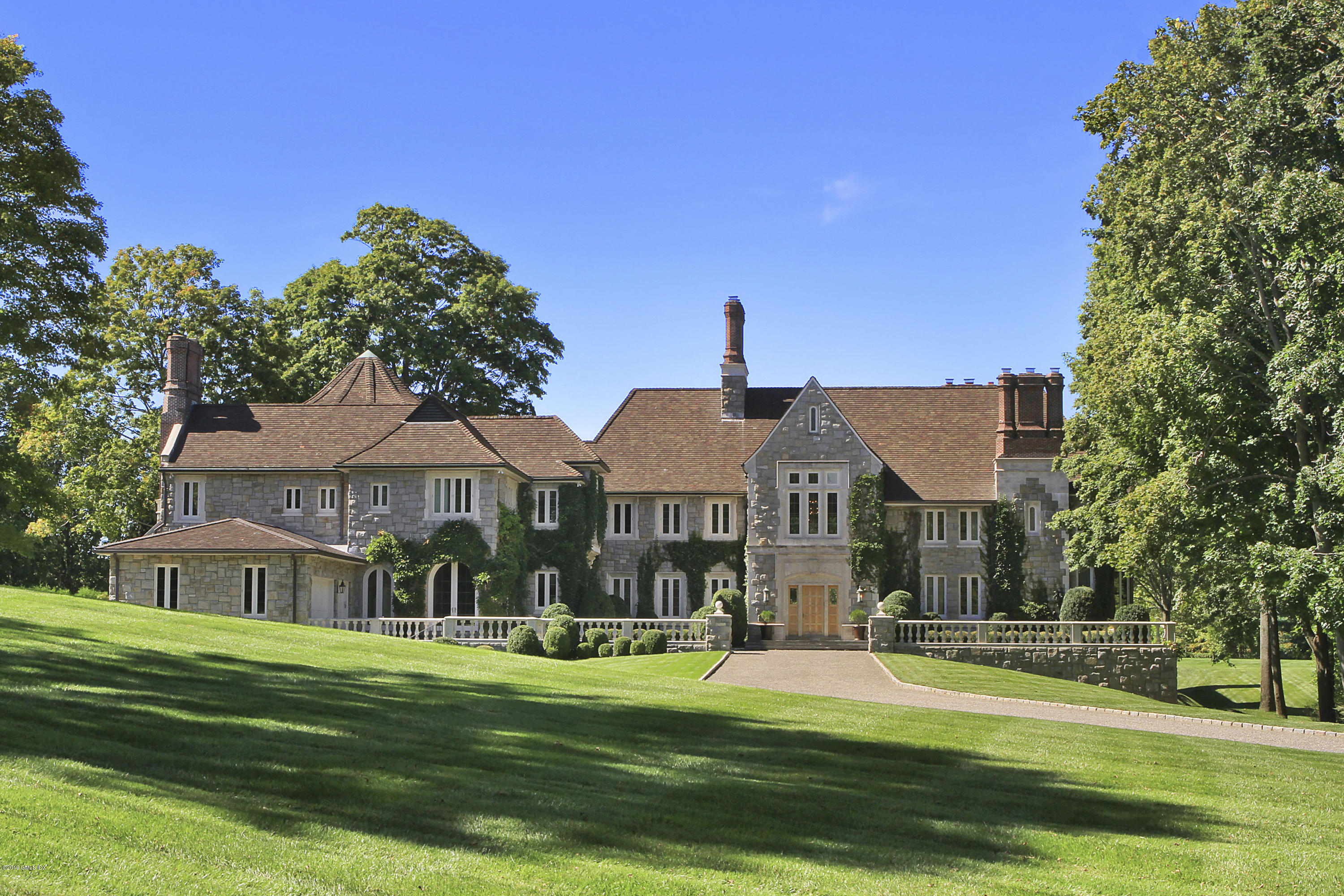 a front view of a house with a yard table and chairs