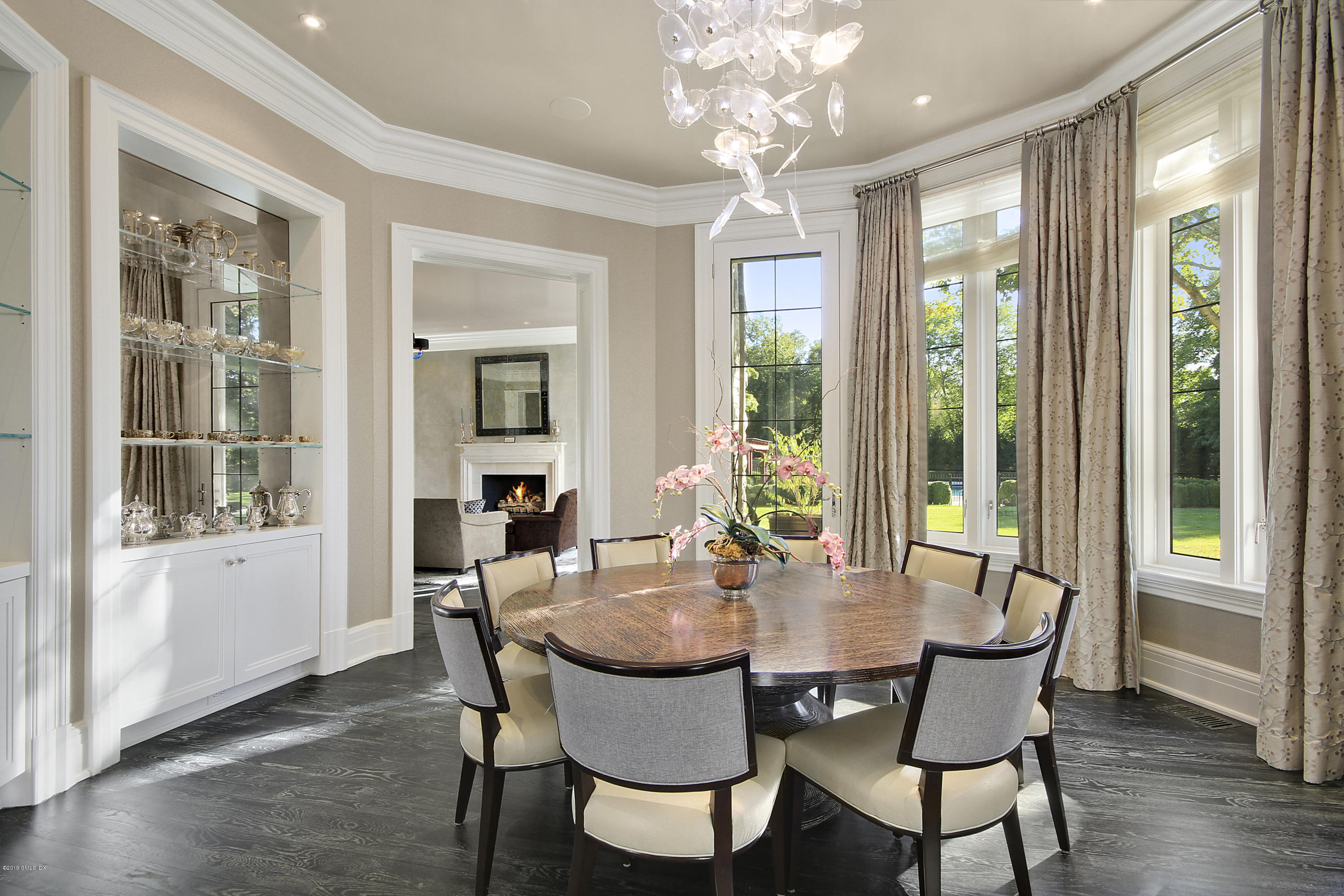 19 Lower Cross Road Greenwich, CT 06831 - Photo 11 of 36 a view of a dining room with furniture large windows and wooden floor