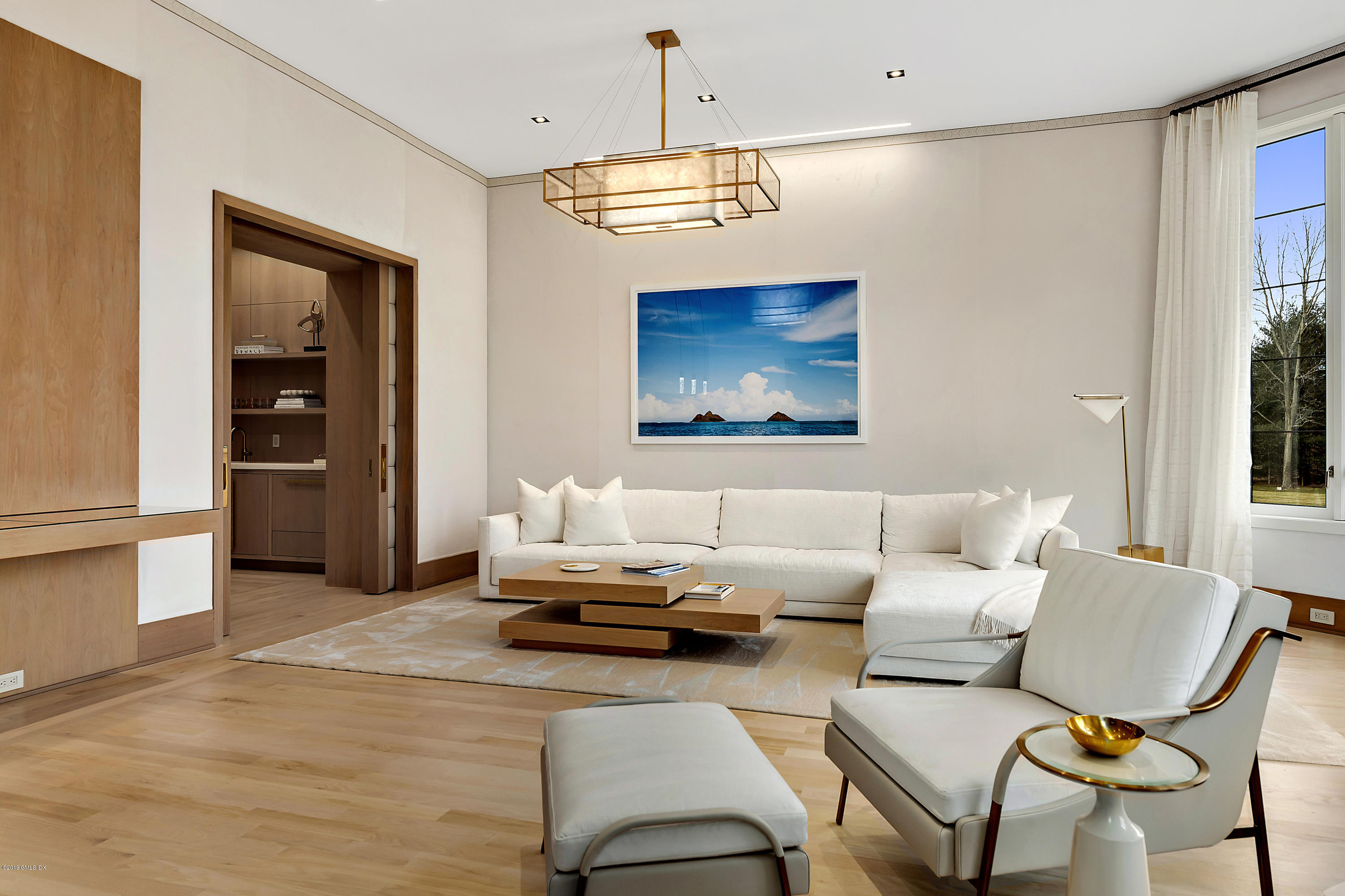 19 Lower Cross Road Greenwich, CT 06831 - Photo 12 of 36 a living room with furniture a window and a chandelier