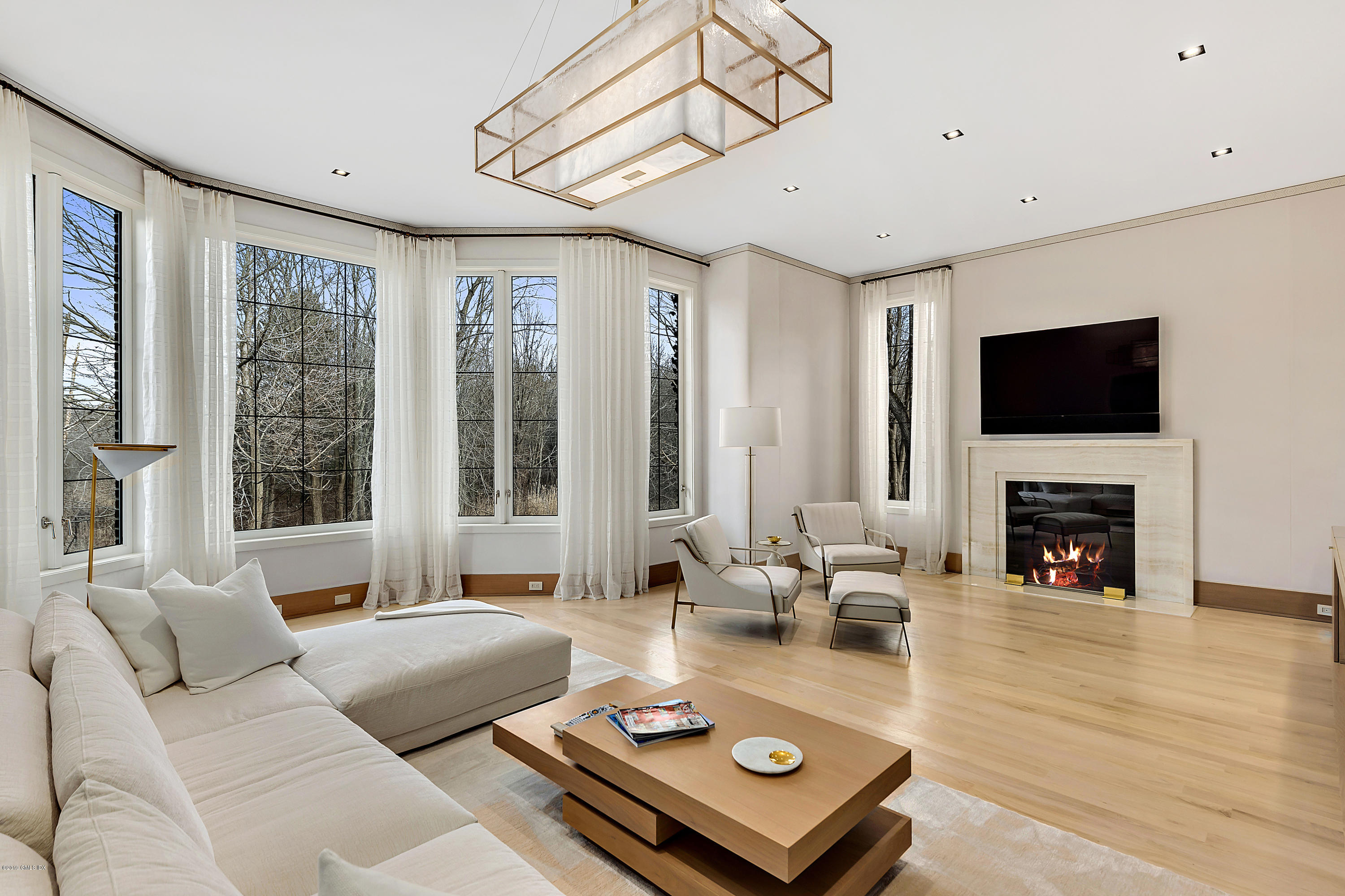 19 Lower Cross Road Greenwich, CT 06831 - Photo 13 of 36 a living room with furniture and a fireplace