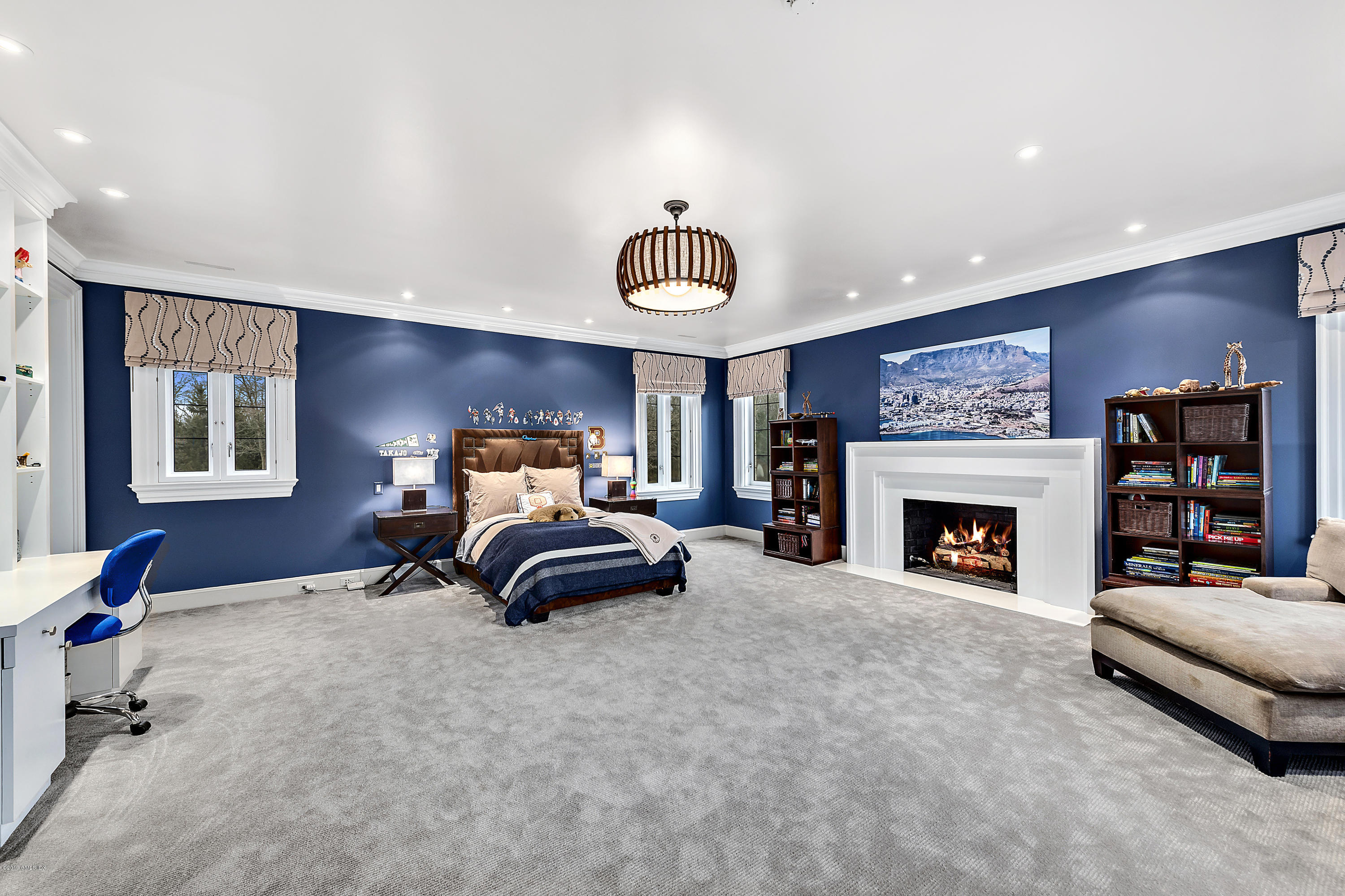 19 Lower Cross Road Greenwich, CT 06831 - Photo 23 of 36 a bedroom with furniture and a fireplace