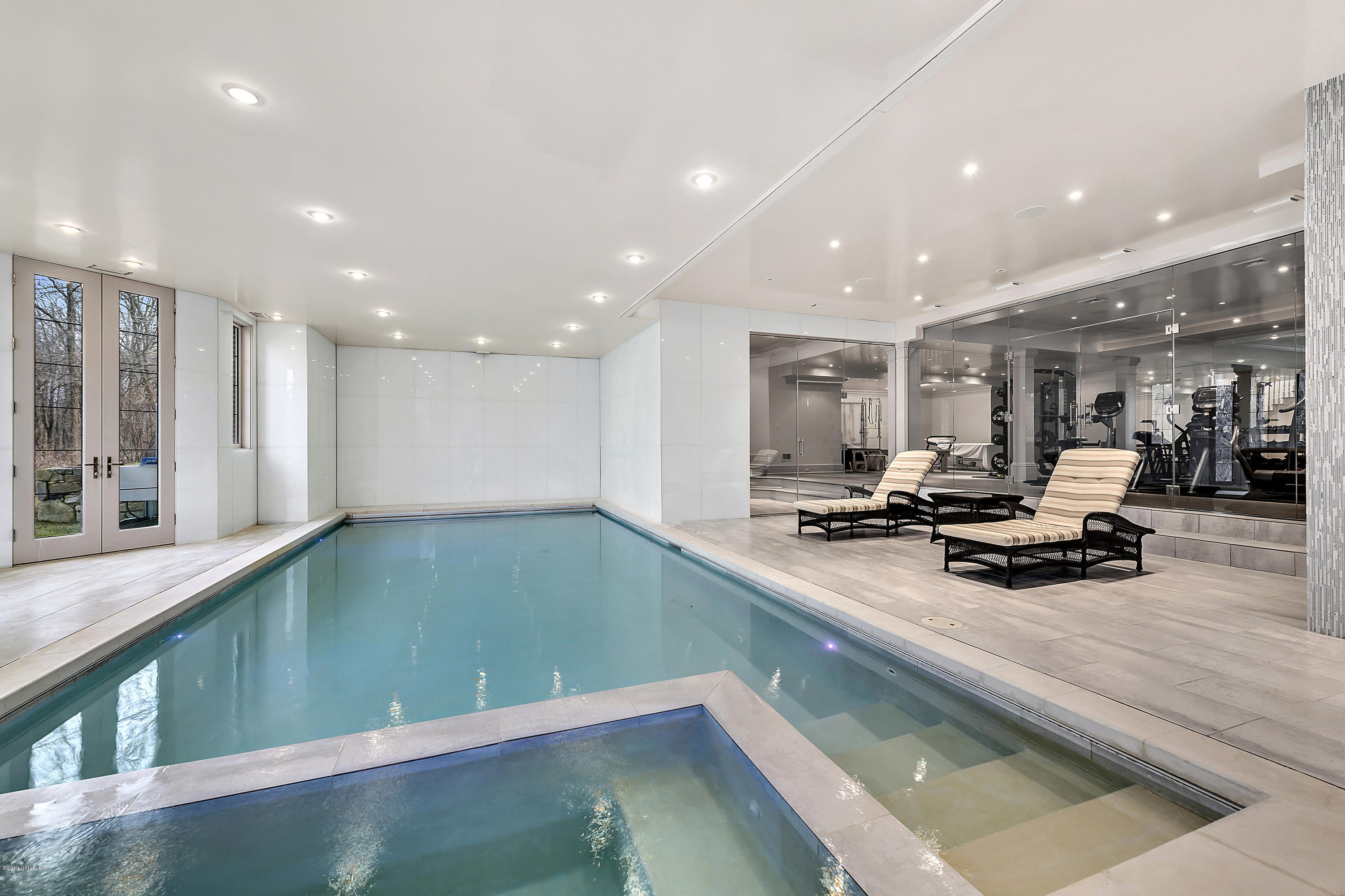 19 Lower Cross Road Greenwich, CT 06831 - Photo 26 of 36 a view of a room with kitchen island stainless steel appliances wooden floor dining table and a large window