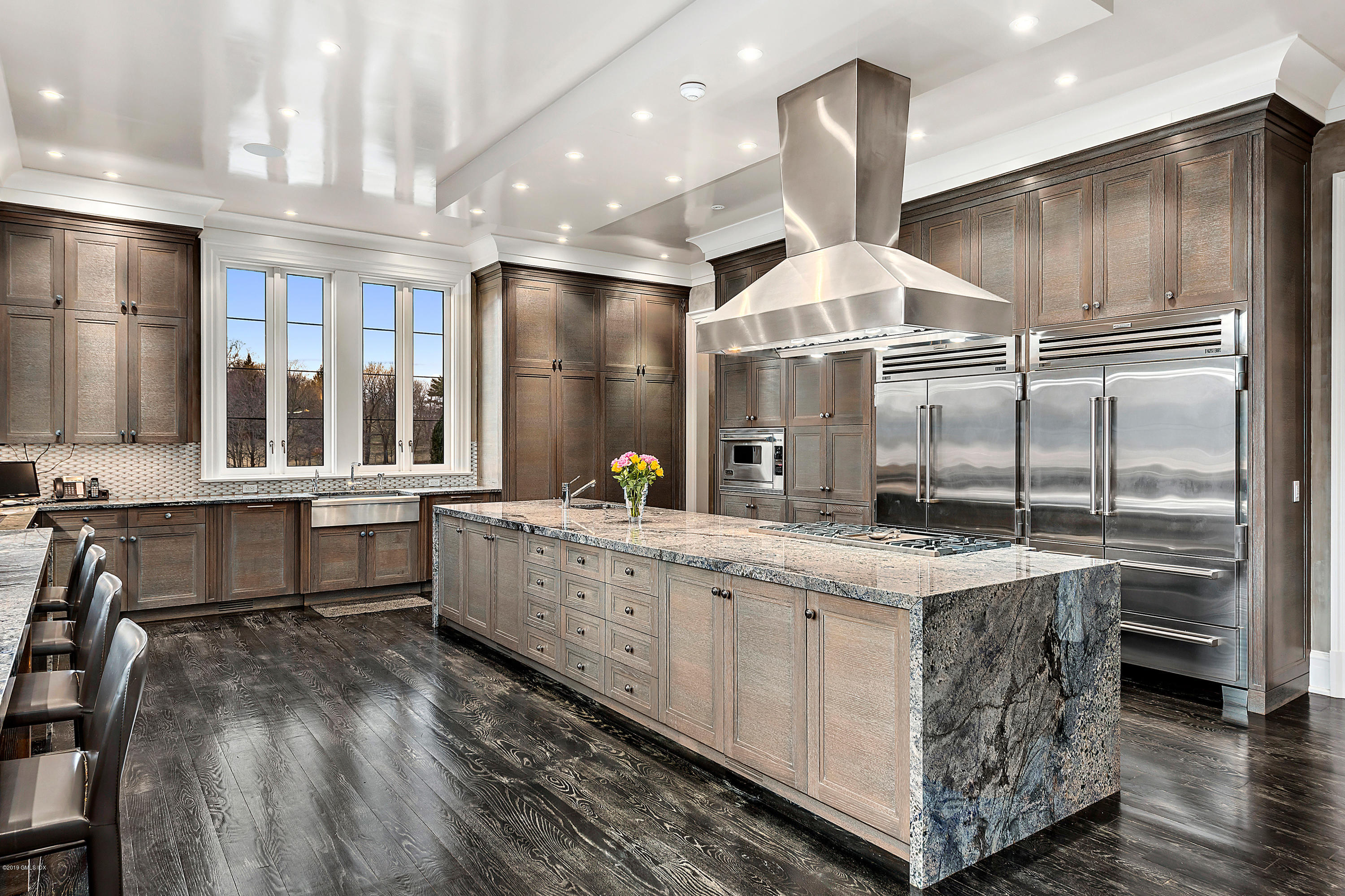 19 Lower Cross Road Greenwich, CT 06831 - Photo 10 of 36 a kitchen with kitchen island granite countertop counter top space a sink stainless steel appliances and cabinets