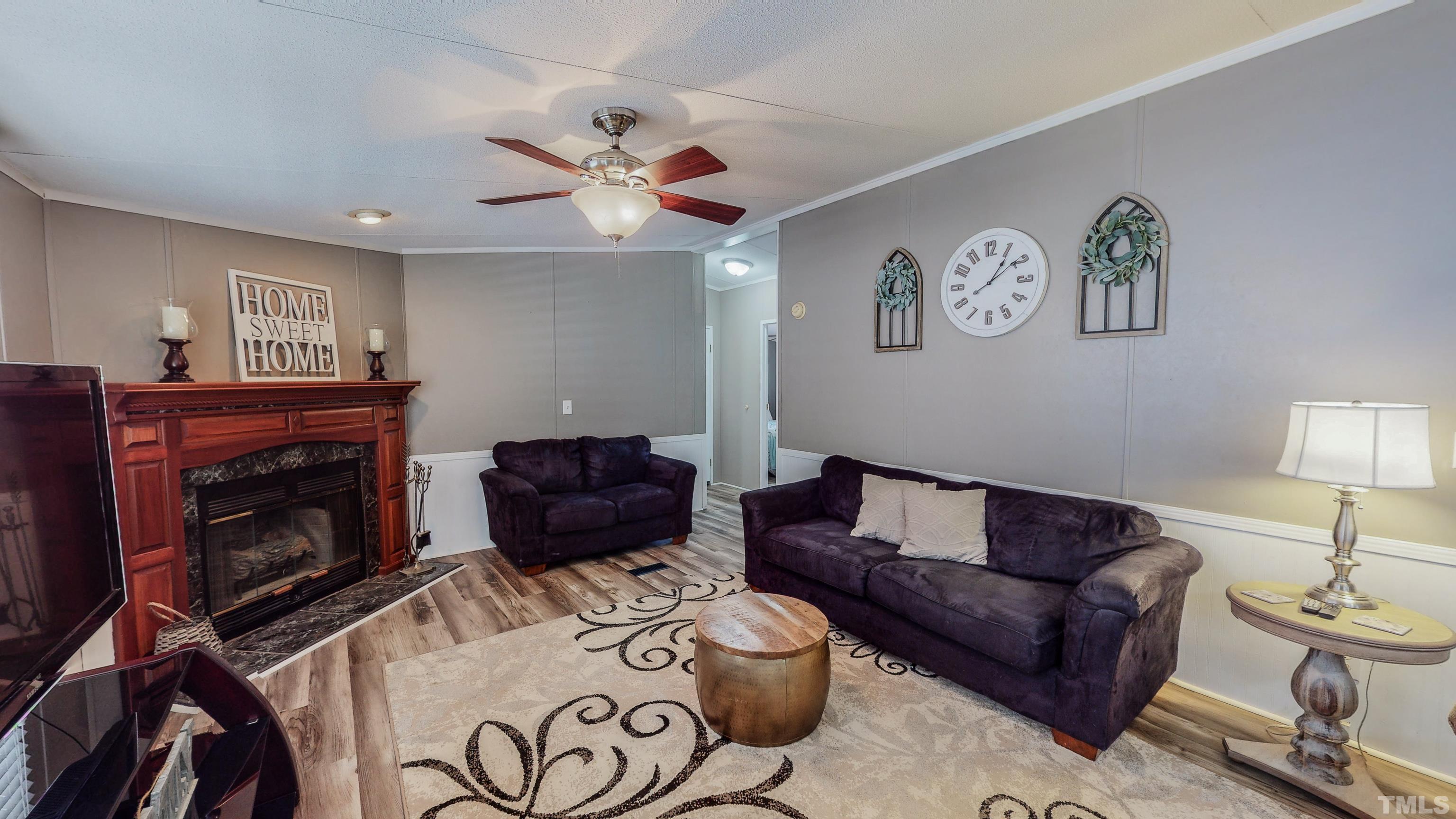 2774 Lucy Garrett Road Timberlake, NC 27583 - Photo 14 of 30 a living room with furniture and a fireplace