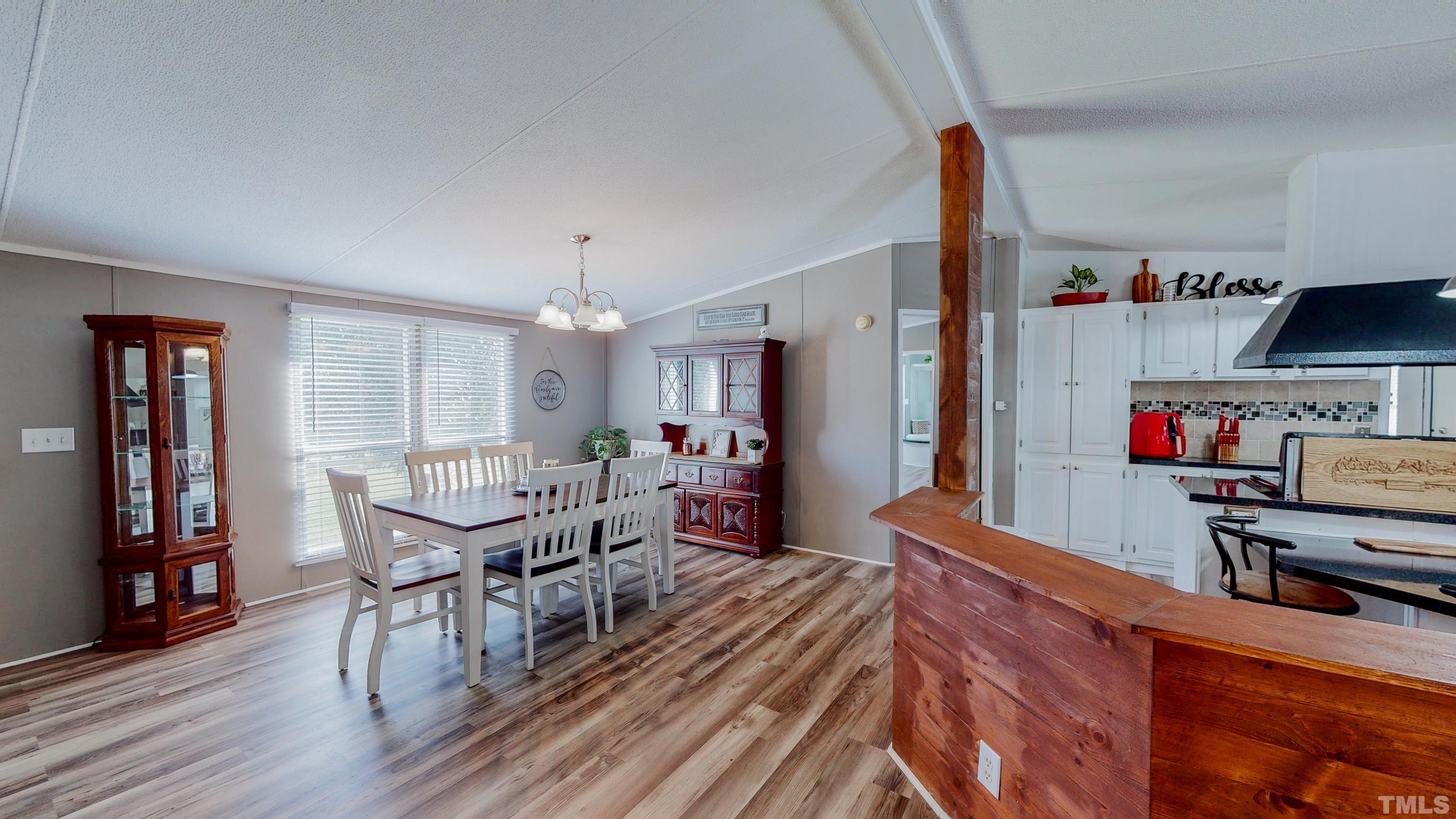 2774 Lucy Garrett Road Timberlake, NC 27583 - Photo 3 of 30 a dining room with furniture and wooden floor