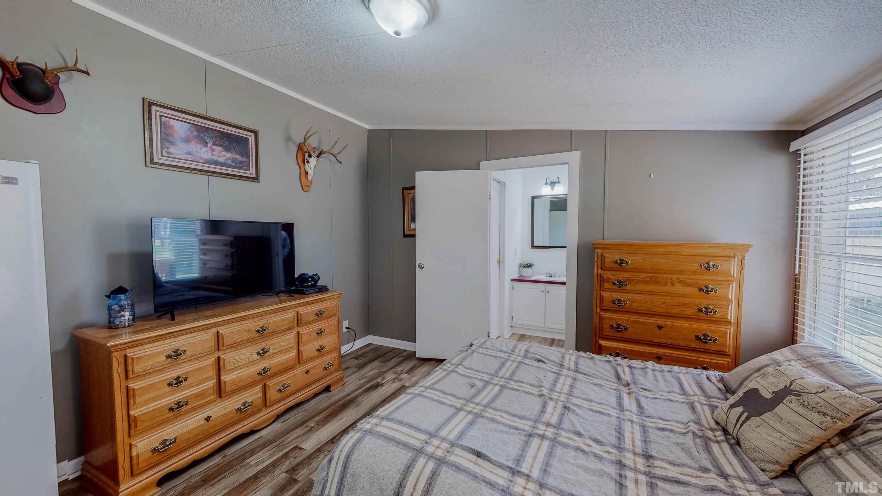 2774 Lucy Garrett Road Timberlake, NC 27583 - Photo 22 of 30 a living room with furniture and flat screen tv